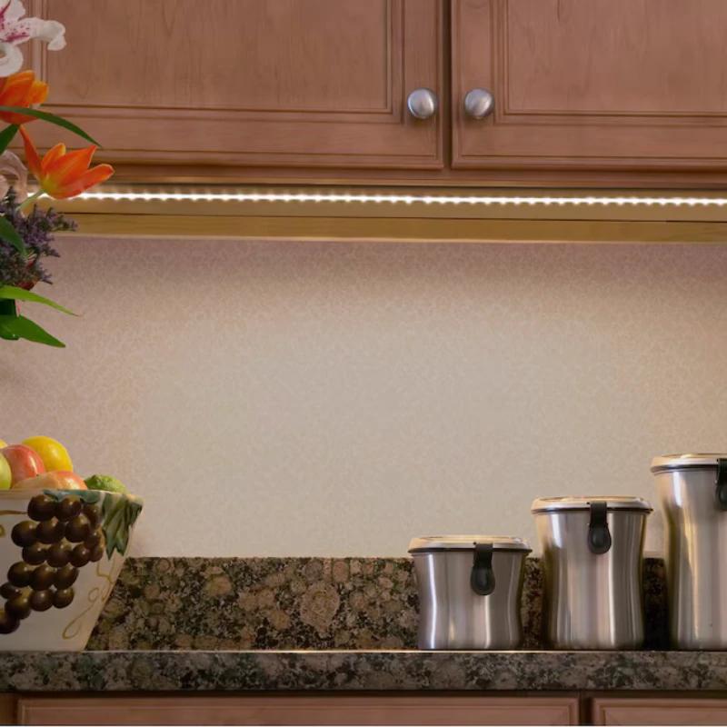 Kitchen under cabinet SMD LED strip lighting providing warm white illumination for countertop workspace and appliances