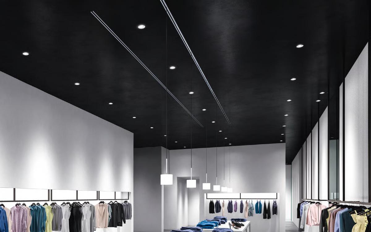 Modern retail clothing store with black ceiling and 3-inch slim round LED downlights with black trim providing focused, dimmable overhead illumination