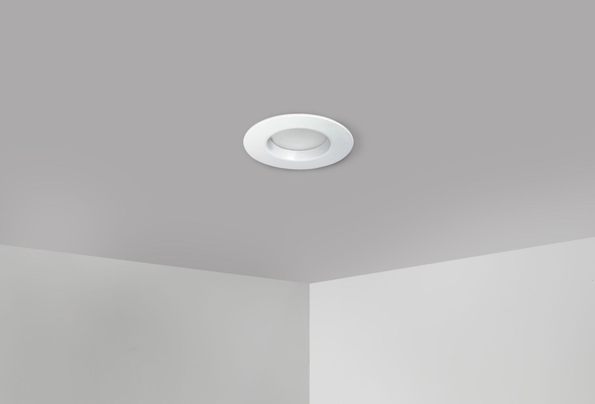 White 5CCT 14W LED recessed retrofit downlight installed in a ceiling corner providing clean, uniform ambient lighting with a slim trim design