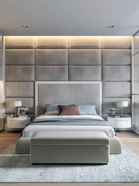 Modern bedroom with padded headboard wall featuring warm white COB LED strip lighting along the top creating soft ambient glow